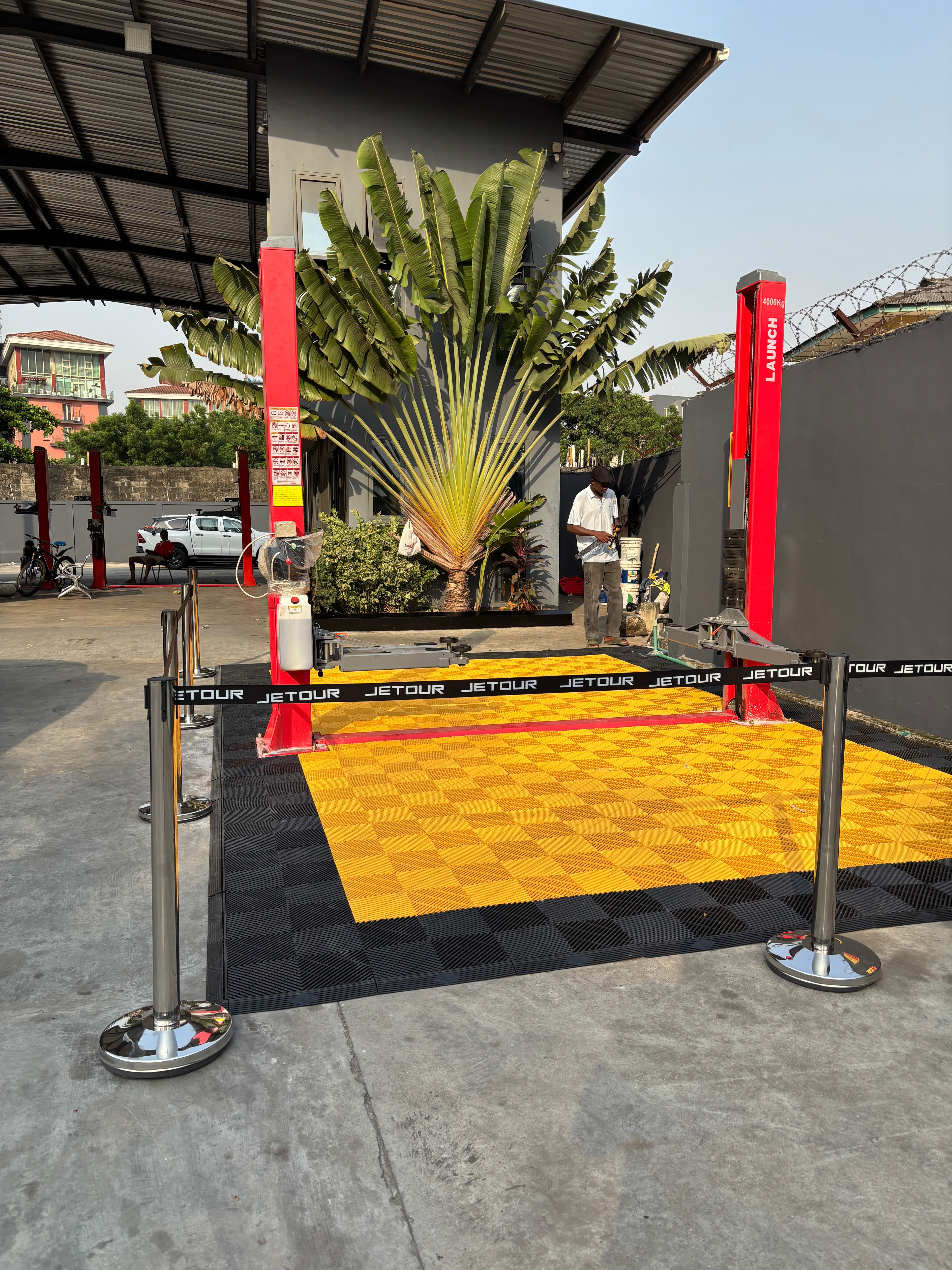 JETOUR auto launch installation — yellow tile event flooring